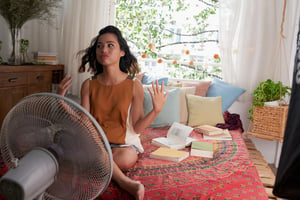 girl with fan in apartment