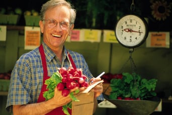 Older_Gentleman_Holding_Vegetables_at_Farmers_Market