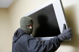 thief stealing a TV off a wall