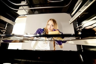 Woman cleaning inside of oven