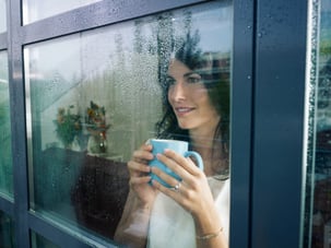 Woman_looking_out_rainy_window_in_apartments_in_chico_california