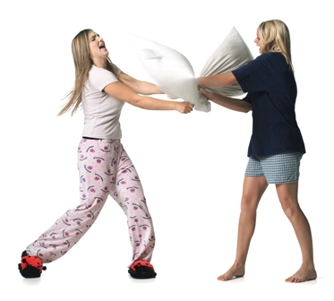 two girls having a pillow fight